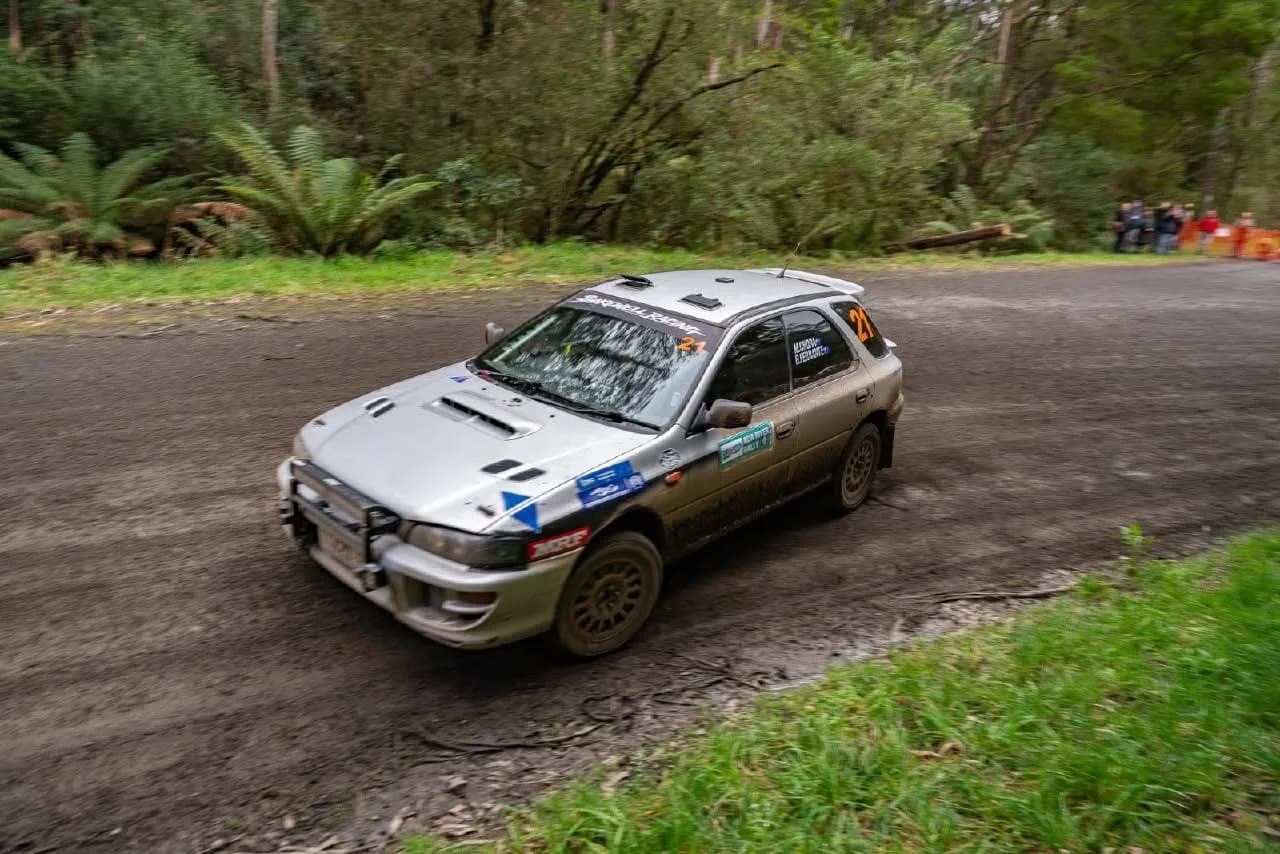 The Shakewell Racing Subaru Impreza wagon, car 21, sliding through a fern-lined gravel corner at the Ada River Rally 2026