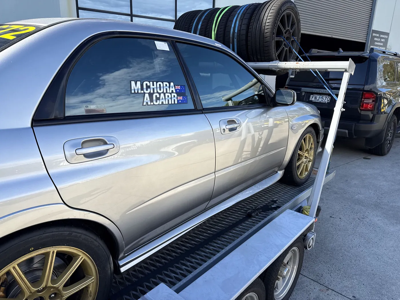 The Shakewell Racing WRX STI loaded back on the trailer with the M. Chora / A. Carr door decal, event over